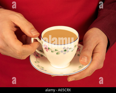 MAN HOLDING CUP OF TEA Stock Photo