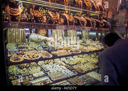 Florence Italy A woman sells jewelry in a shop on the Ponte Vecchio a bridge spanning the River Arno Stock Photo