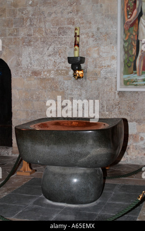 Baptismal font of polished polyphant stone and beaten copper at Chichester Cathedral, West Sussex, England, UK Stock Photo