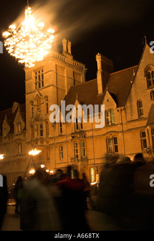 Chandelier of fire swinging against [Balliol College] at night, [Luminox Fire Festival], "Broad Street", Oxford, England, UK Stock Photo