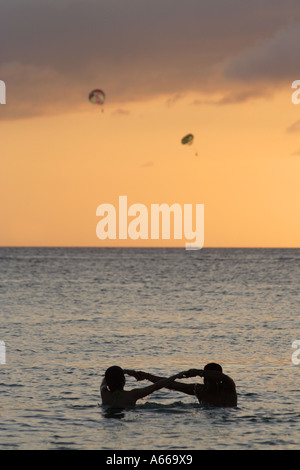 Young Filipino couple on their honeymoon embrace on the beach on Boracay at Sunset, Philippine Islands Stock Photo