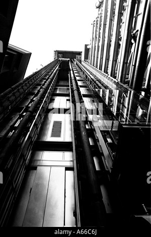 Lloyds of london in black and white with its lovely clean lifts on the outside of the building Stock Photo