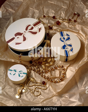 Close-up of small stencilled wooden boxes on gold tissue paper Stock Photo