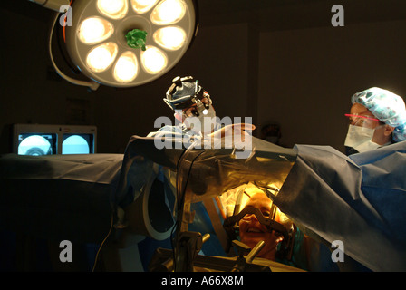 Brain surgeon performs a delicate brain procedure on an awake patient called Deep Brain Stimulation DPS Stock Photo