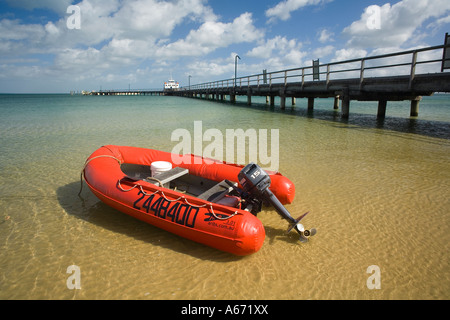 A red zodiac floats in the clear waters of Kingfisher Bay on Fraser Island Stock Photo