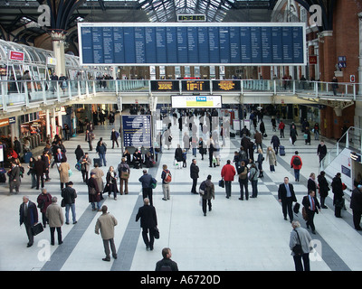 Liverpool Street Train Station Looking down at people on main passenger concourse & commuters below departure board in City of London England UK Stock Photo