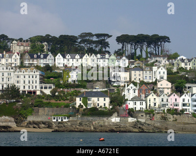 River Fowey and riverside hillside landscape of white painted housing in town of Fowey with backdrop of trees in Cornwall England UK Stock Photo
