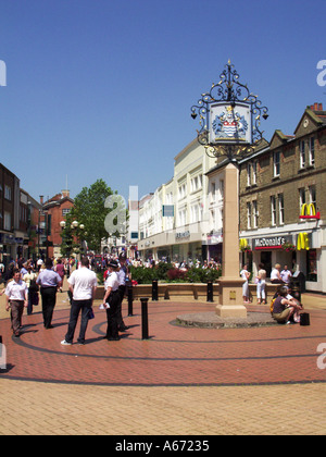 Chelmsford City sign in high street shopping centre people in pedestrianised road on a blue sky day & police officers attending in Essex England UK Stock Photo