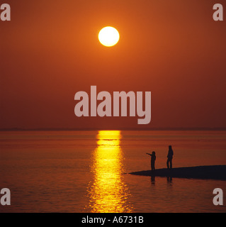 Couple on beach sunset Stock Photo