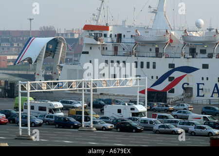 Cross Channel ferry Renoir with bow doors open Port of Calais northern France Cars caravans vechicles wait on the dockside to em Stock Photo