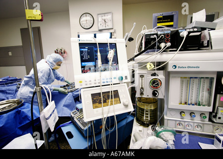 machines for monitoring vital signs and regulating dosages used by anesthesiologist in operating room Stock Photo