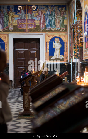 People lighting candles and praying inside of Chisinau Cathedral Chisinau Moldova Stock Photo