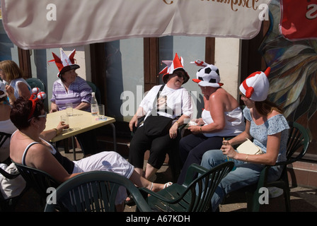 Hen party group 2000s UK Lady world cup football fans wearing traditional funny England hats drinking outside a pub. Southend on Sea Essex 2006 Stock Photo