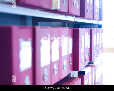 a row of red files on a shelf Stock Photo