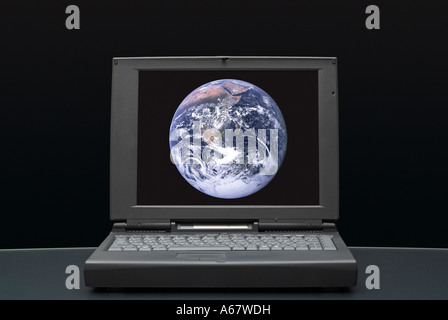 Laptop Computer with Planet Earth Displayed on the Screen Against a Black Background Stock Photo