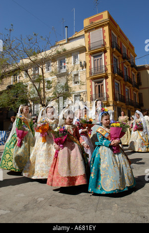 Young Falleras in traditional Valencian costume during L'Ofrena de flors flower offering march during Las Falles festival held in Valencia city Spain Stock Photo