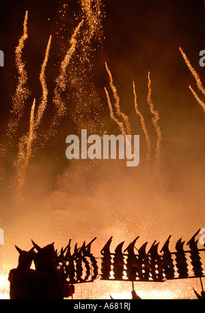 Fallers with fireworks going off during Cavalcada del Foc the Fire Parade during Las Falles traditional festival held in the city of Valencia Spain Stock Photo