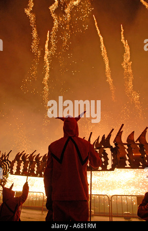 Fallers with fireworks going off during Cavalcada del Foc the Fire Parade during Las Falles traditional festival held in the city of Valencia Spain Stock Photo