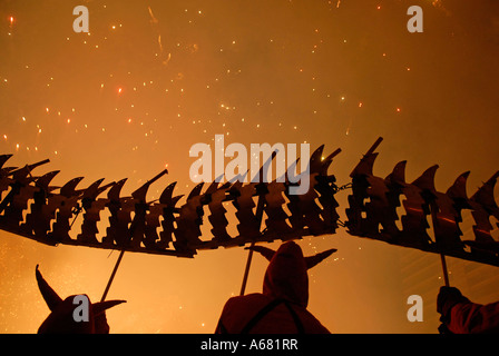 Fallers with fireworks going off during Cavalcada del Foc the Fire Parade during Las Falles traditional festival held in the city of Valencia Spain Stock Photo