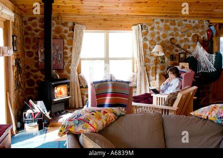 Peaceful moment reading in a gorgeous lodge deep in the woods.  Cable Wisconsin USA Stock Photo