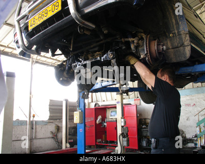 a mechanic working at a car garage in the industrial park of the city of Holon Israel Stock Photo