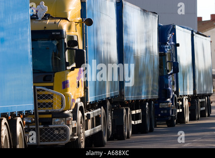 Trucks parked tightly behind the trailer of another truck , Finland