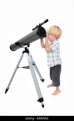 Young child or boy looking through a telescope with white isolated background Stock Photo