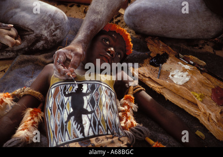 Aboriginal boy being painted with his totems for his initiation ceremony Arnhem Land by tribal elders Stock Photo