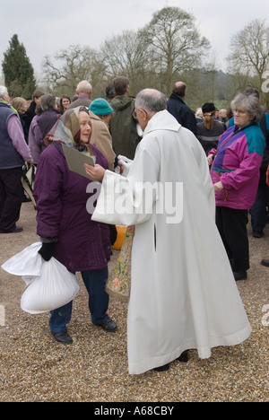 Roman Catholic priest talking to parishioner at Tichborne Dole Tichborne near Arlesford Hampshire UK Annually on Lady Day March 25th 2007 2000s Stock Photo