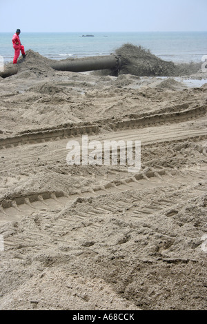 Pouring sand suck from the sea on the beach in Malaysia Stock Photo - Alamy