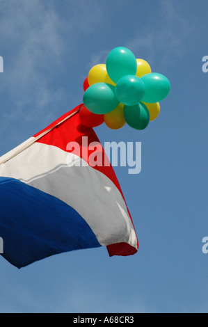 national flag of Holland flying on a pole with balloons Stock Photo