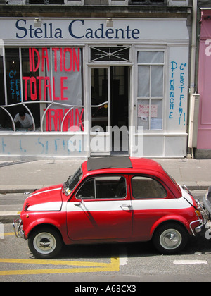 red Fiat 500 parked by roadside at Quai de Valmy 10th arr. Paris, Stock Photo