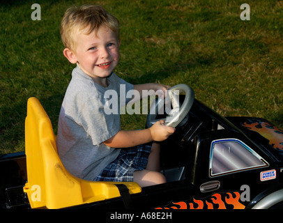 Three year old boy in toy truck Stock Photo