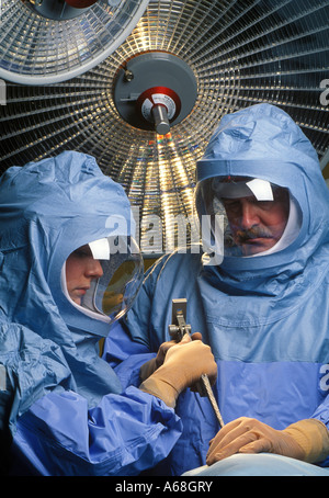 Orthopedic surgeon in protective surgical suits used to avoid infection during joint replacement surgery hip knee Stock Photo