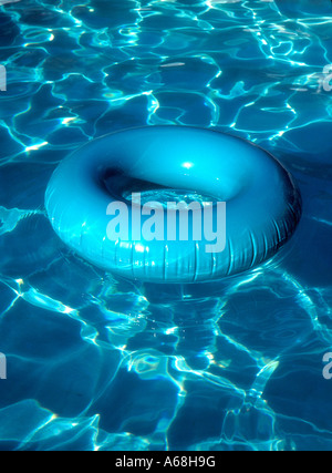 Aqua innertube with pool reflections Stock Photo