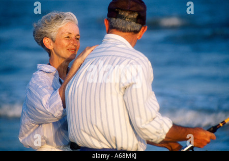 Senior couple spending time together and surf fishing Stock Photo