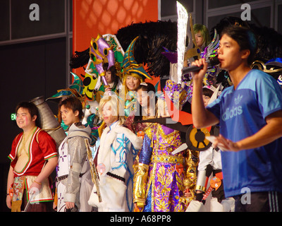 Large group of people dressed as comic book characters on stage at The Hong Kong Animax Convention 2004 Stock Photo