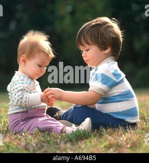 Two small boys playing on the beach in Northumberland Stock Photo - Alamy