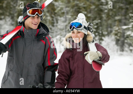 couple walking with skis in winter Stock Photo