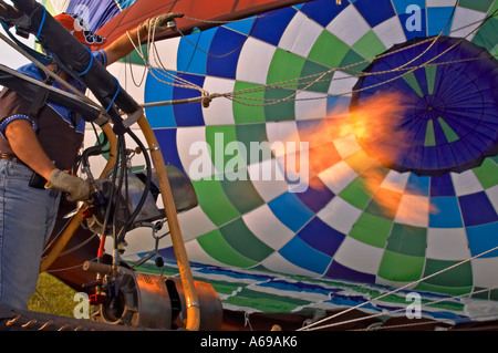 Inflating an air balloon with hot air with help of gas-jet Stock Photo