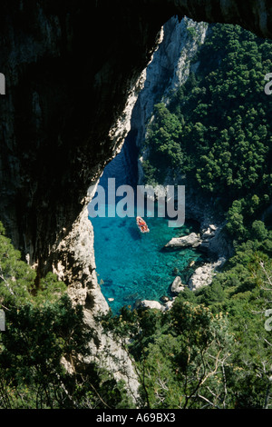 Capri Italy View of pleasure boat through The Arco Naturale a 200 metre high natural arch Stock Photo