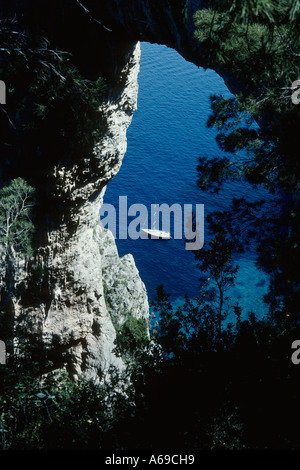 Capri Italy View of pleasure boat through The Arco Naturale a 200 metre high natural arch Stock Photo