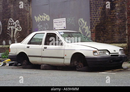 Vandalised car with it's wheels removed and stolen in London street. Stock Photo