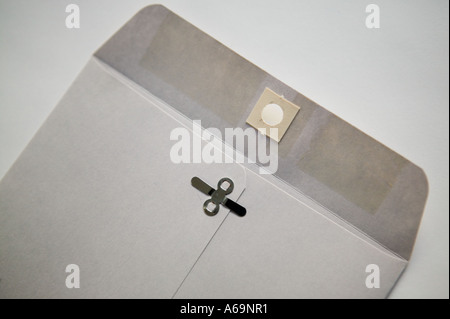 Studio shot of an open plain grey envelope on a white surface 2006 Stock Photo