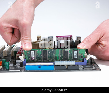 hands installing RAM Stock Photo