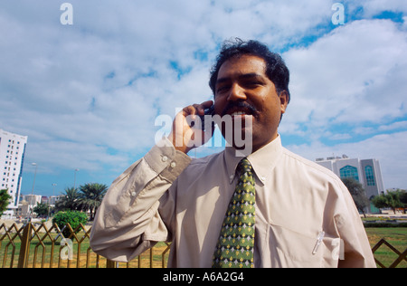 Abu Dhabi UAE Indian Guest Worker On Mobile Phone Stock Photo