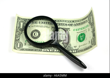 Magnifying glass on top of a dollar bill isolated on white Stock Photo