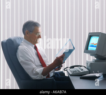 businessman reading financial report in office Stock Photo