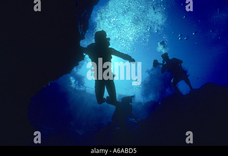 two skin divers exploring cave in Florida spring Stock Photo