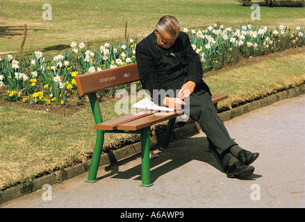 Elderly white man sleeping on EUROPEANS ONLY park bench in Joubert Park in Johannesburg South Africa Taken in 1973 Stock Photo